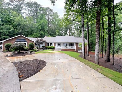 Ranch-style home with covered porch and curved driveway