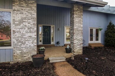 The large covered front porch offers guests protection during inclement weather.  The front door features a new brushed nickel lock set, and the adjacent 