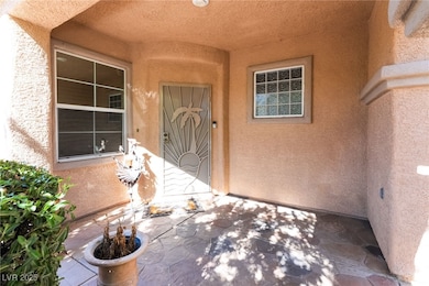Doorway to property featuring stucco siding and a patio