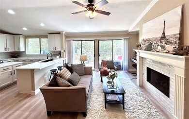 Living room featuring a brick fireplace, light har