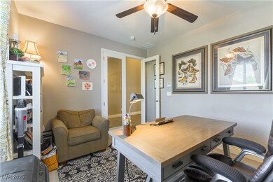 Office with a ceiling fan and french doors