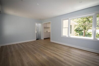 Unfurnished bedroom with multiple windows, vinyl finished floors, and a spacious closet