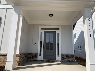 View of exterior entry featuring board and batten 