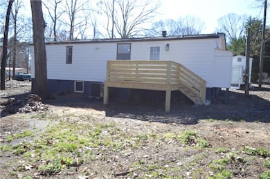 Rear view of property featuring a deck