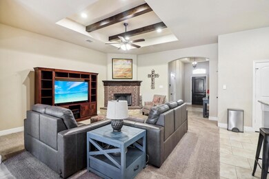 Tiled living room with beamed ceiling, a tray ceil