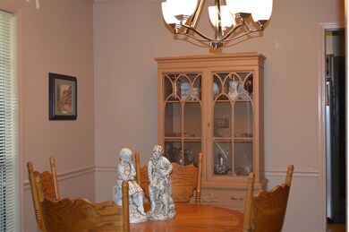 Dining Room has a new chandelier and laminate wood