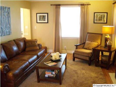Family Room equipped with gas logged fireplace-crown molding & laminate flooring