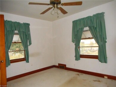 Master Bedroom: Room features include thick carpet flooring, two window for natural light and a ceiling fan with light. To the left side is the closet door.