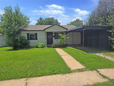 Ranch-style house with a front lawn and a carport
