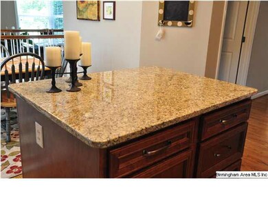 The granite counter island has convenient storage 