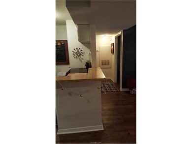 Corridor featuring dark hardwood / wood-style floo