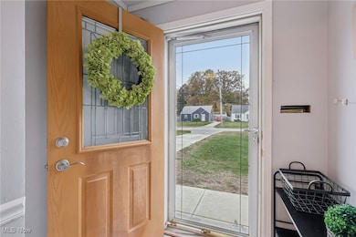 entry with quality front door and storm door, coat closet behind the door