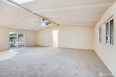 To the other side of the entry, discover a spacious living room with vaulted ceilings and fresh paint throughout—warm and welcoming from the moment you arrive.