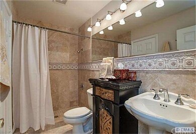 Remodeled bathroom with travertine shower and floo