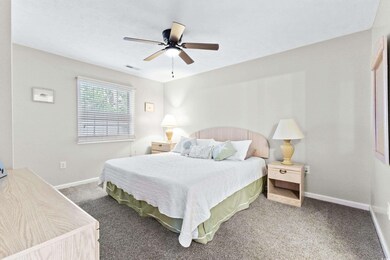Carpeted bedroom with ceiling fan