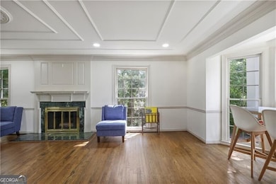 Fireside living room with beautiful ceiling detail.