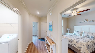 Bedroom featuring ceiling fan, light hardwood / wo
