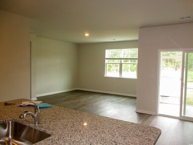Kitchen with wood finished floors, recessed lighting, and light stone countertops