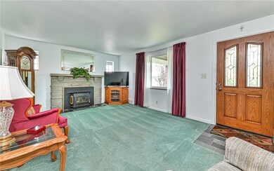 Spacious living room with cozy wood burning firepl