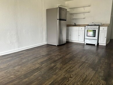 Kitchen featuring freestanding refrigerator, open