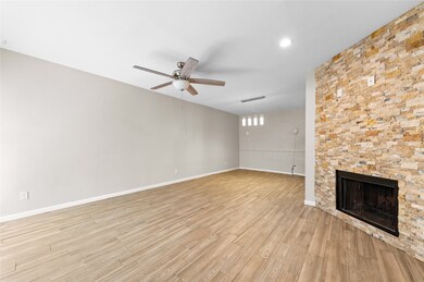 Relax by the cozy fireplace in the spacious, open-