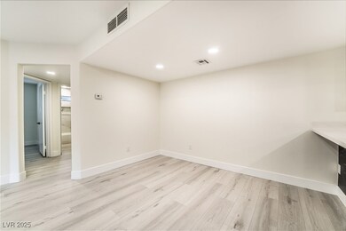 Empty room featuring baseboards, visible vents, an