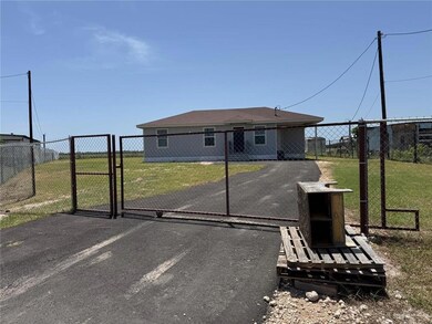 View of front of home featuring a gate and driveway