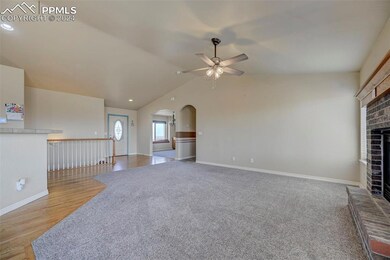 Unfurnished living room with a fireplace, lofted c