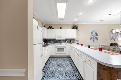 Kitchen with crown molding, kitchen peninsula, whi