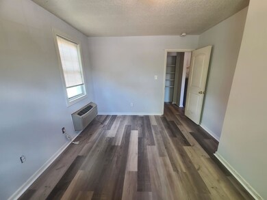 Unfurnished living room with a textured ceiling, a