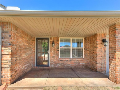 Doorway to property featuring brick siding
