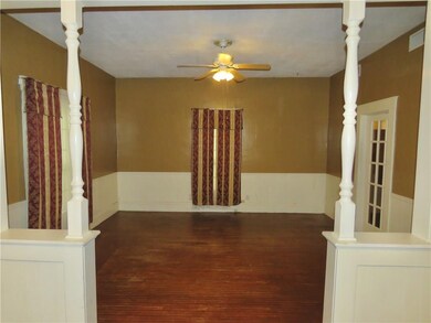 Living room.  French door to the right lead to the possible bedroom or another living area/office.