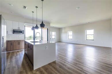 Step into an open-concept masterpiece featuring soaring 10-foot ceilings and an expansive living, dining, and kitchen area that maximizes both form and function.