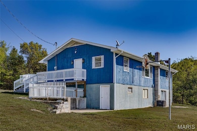 Rear view of property with a lawn and a wooden deck