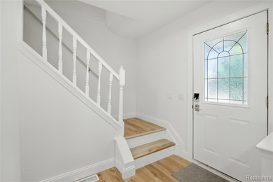Entryway with stairs and light wood-type flooring