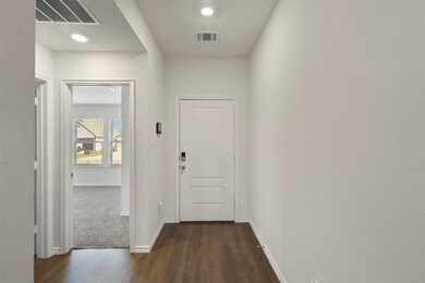 Entryway featuring dark wood-type flooring and baseboards