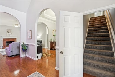 Stairs with ceiling fan, hardwood / wood-style flo