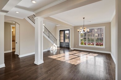 Unfurnished dining area with crown molding, dark h