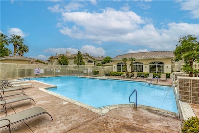 Pool featuring a patio and fence