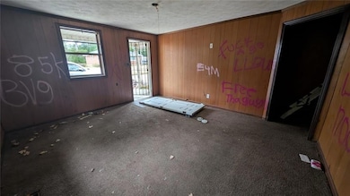 Unfurnished room with crown molding, dark colored 