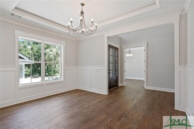 The formal dining room is flooded with natural lig