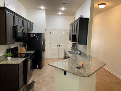 Galley Kitchen with double pantry with black appli