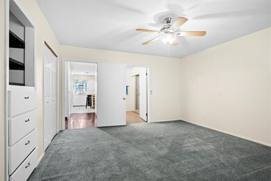 Unfurnished bedroom with ensuite bath, a ceiling f