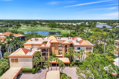Aerial view of a local golf course, a nearby body of water, and a tree filled landscape
