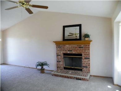Living room w/vauted ceiling, woodburning fireplac