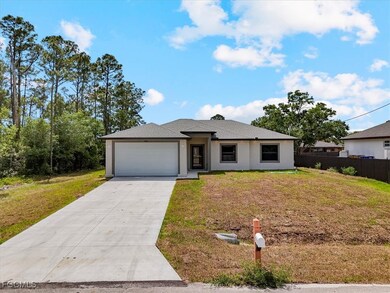 View of front of house with driveway, a garage, an