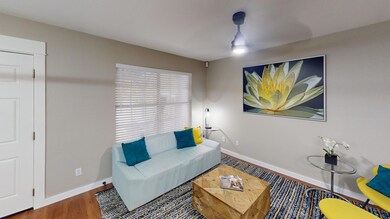 Living room with baseboards and wood finished flo