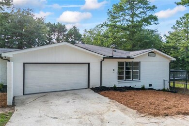Ranch-style house featuring brick siding, concrete driveway, and a garage