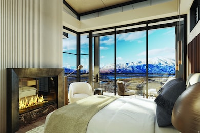 Bedroom with a fireplace, a water and mountain view, multiple windows, and wood finished floors