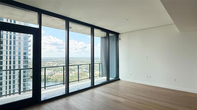 Unfurnished room with a wall of windows, light wo